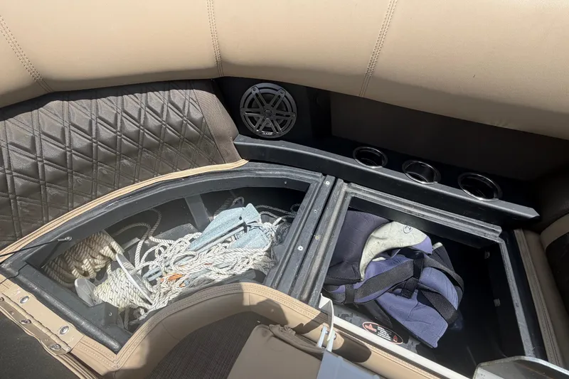 Slide: The Image of Storage compartments in a 2021 Harris Solstice 230 boat, containing ropes and life jackets. - 62