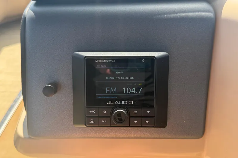 Slide: The Image of Radio display on 2021 Harris Solstice 230, tuned to FM 104.7, playing Blondie's "The Tide Is High". - 54