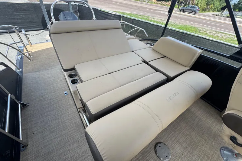 Slide: The Image of 2021 Harris Solstice 230 boat interior with beige seating and cup holders. - 24
