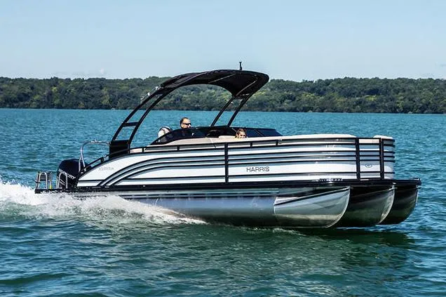 Slide: The Image of Manufacturer Provided Image: 2021 Harris Solstice 230 pontoon boat cruising on a lake. - 1