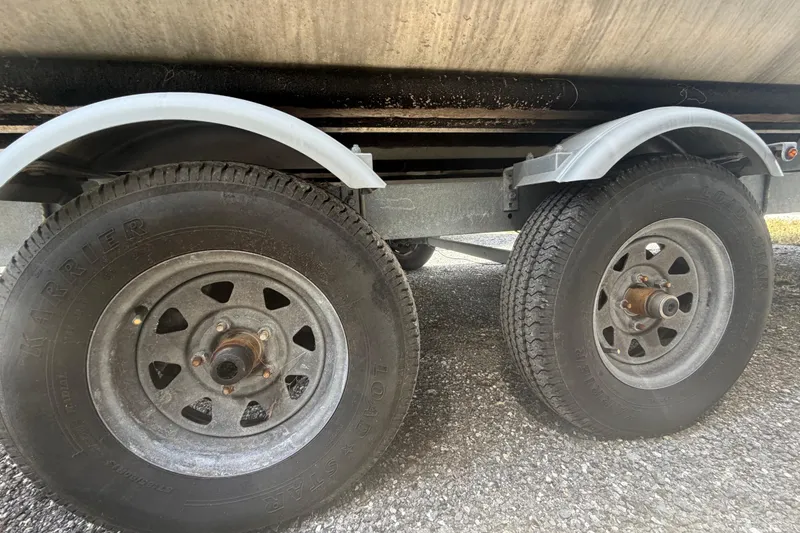 Slide: The Image of Trailer wheels of a 2021 Harris Solstice 230 on gravel surface. - 70