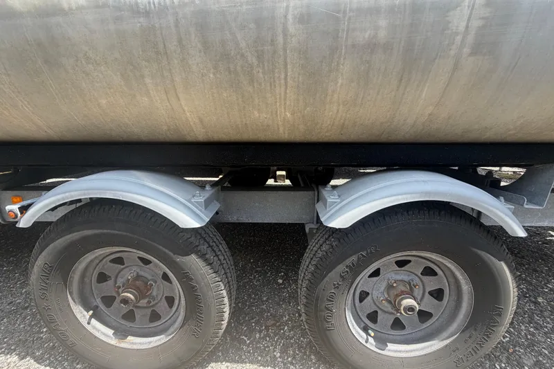 Slide: The Image of Trailer wheels and fenders of a 2021 Harris Solstice 230 on gravel surface. - 69