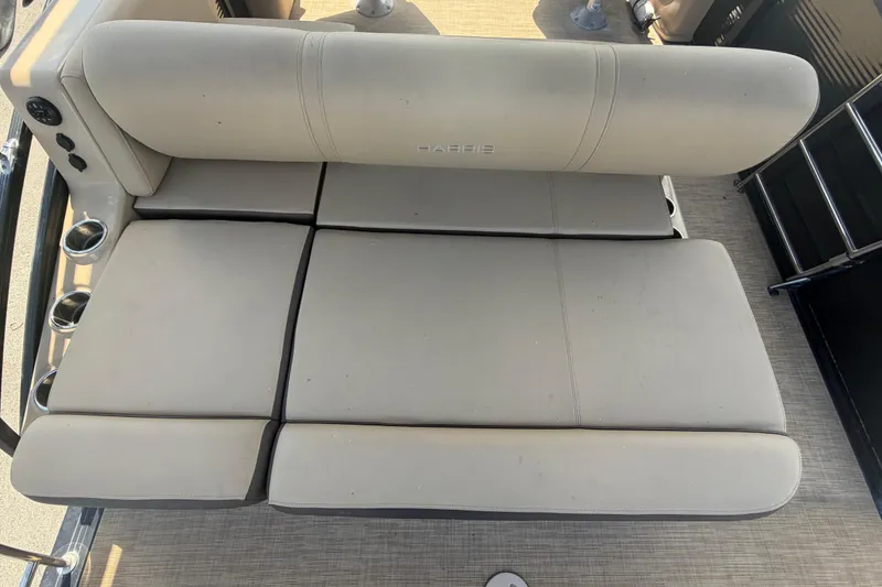 Slide: The Image of 2021 Harris Solstice 230 boat seating with beige upholstery and cup holders. - 36