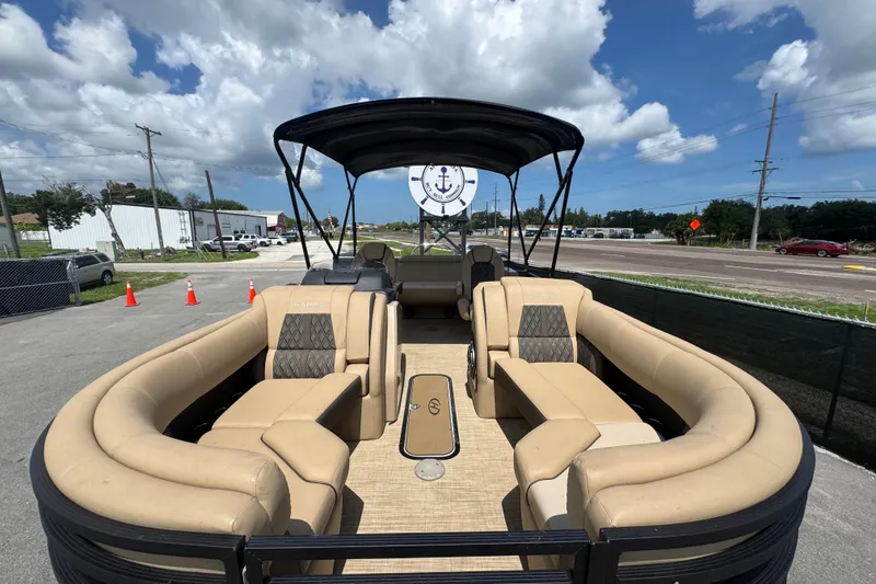 Slide: The Image of 2021 Harris Solstice 230 pontoon boat with beige seating and black canopy. - 10