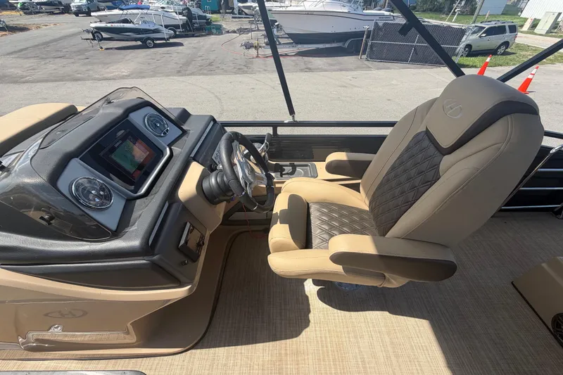 Slide: The Image of Captain's seat and dashboard of 2021 Harris Solstice 230 boat, featuring modern controls and upholstery. - 49