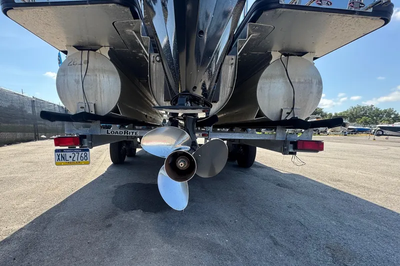 Slide: The Image of Rear view of 2021 Harris Solstice 230 boat on trailer, showcasing propeller and pontoons. - 4