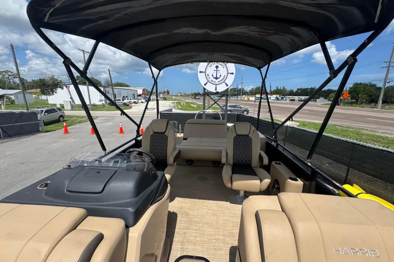 Slide: The Image of Interior view of a 2021 Harris Solstice 230 pontoon boat with beige seating and canopy. - 12