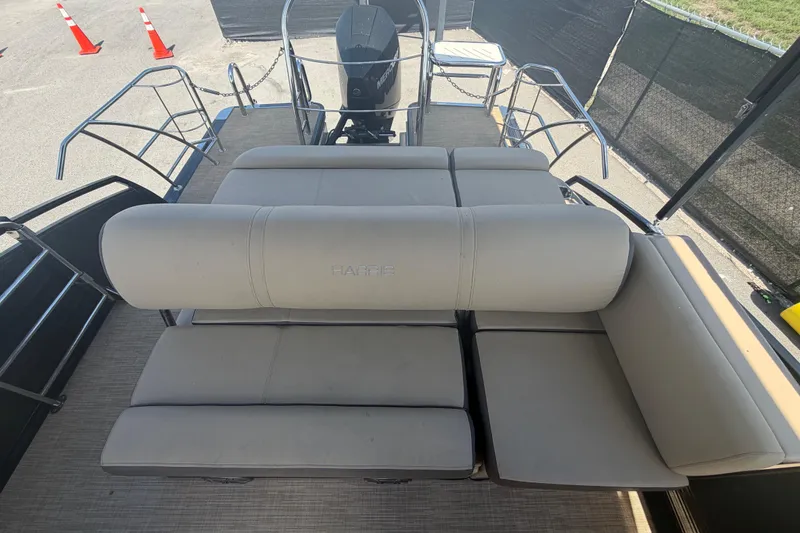 Slide: The Image of 2021 Harris Solstice 230 pontoon boat with beige seating and Mercury outboard motor. - 20
