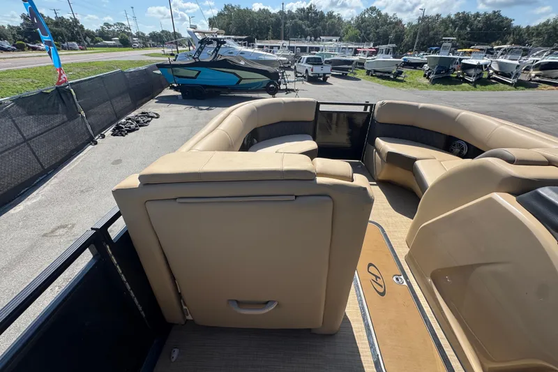 Slide: The Image of 2021 Harris Solstice 230 pontoon boat with beige seating, parked in a marina. - 44