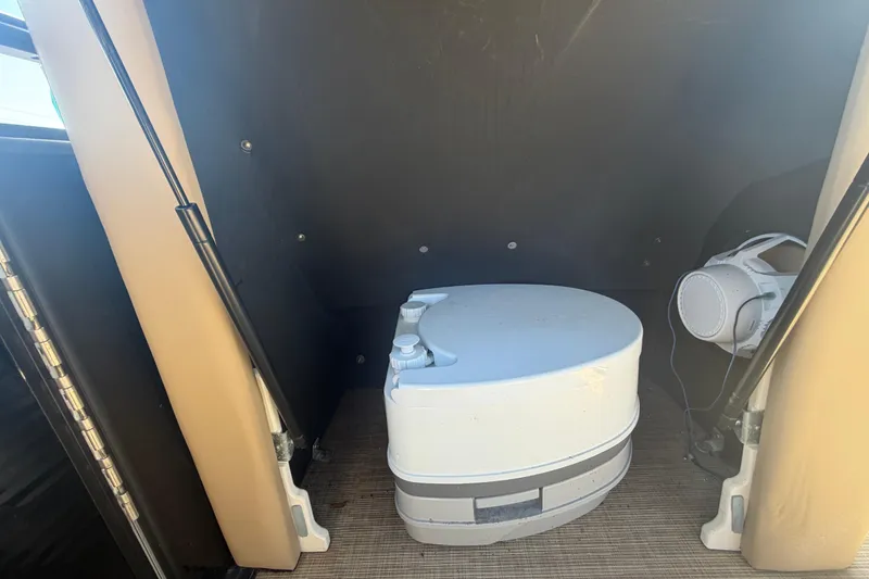 Slide: The Image of Portable toilet inside 2021 Harris Solstice 230 boat compartment. - 47