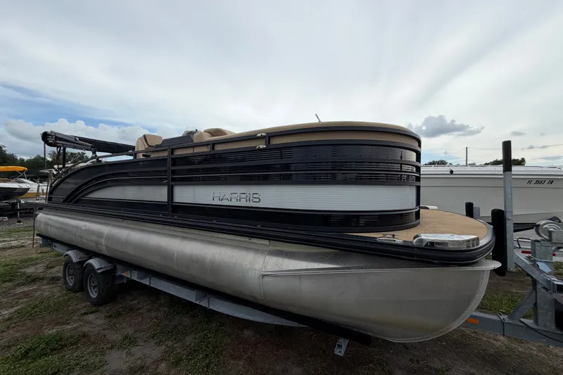 The Image of 2021 Harris Solstice 230 pontoon boat on trailer, side view, overcast sky. - 0