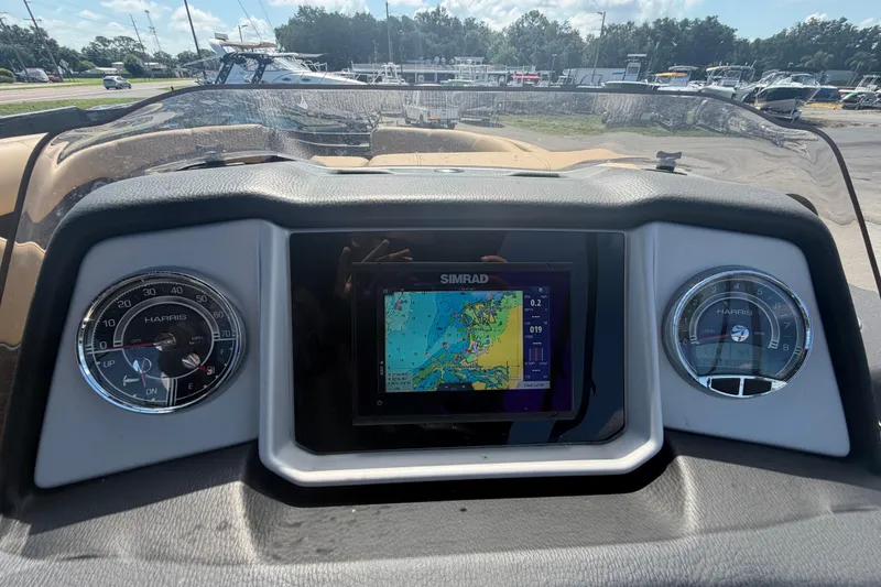 Slide: The Image of Dashboard of 2021 Harris Solstice 230 boat with navigation display and gauges. - 53