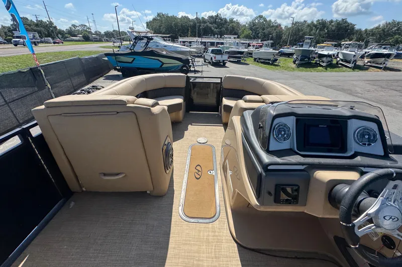 Slide: The Image of Interior view of a 2021 Harris Solstice 230 pontoon boat with beige seating. - 43
