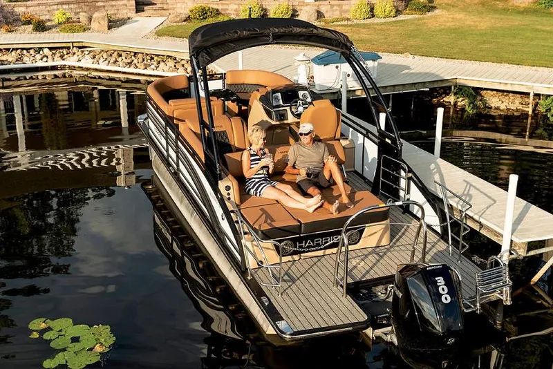 Slide: The Image of Manufacturer Provided Image: 2021 Harris Solstice 230 pontoon boat docked with two people relaxing onboard. - 7