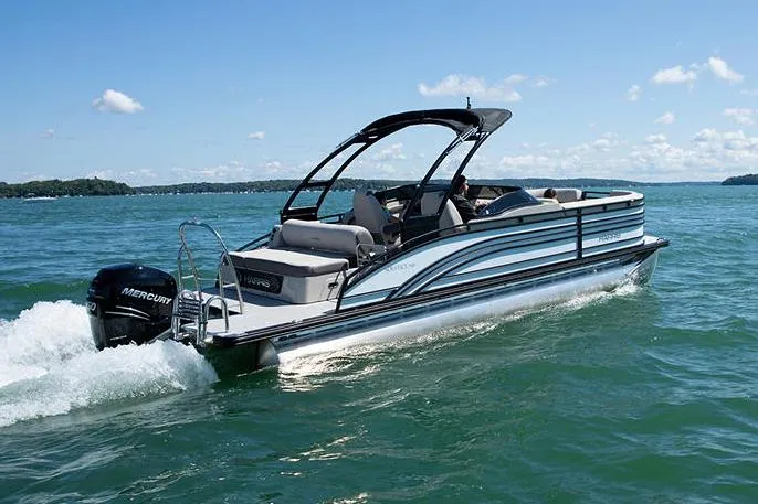 Slide: The Image of Manufacturer Provided Image: 2021 Harris Solstice 230 pontoon boat cruising on a lake. - 3
