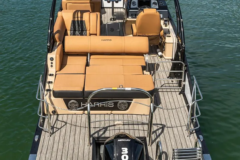 Slide: The Image of Manufacturer Provided Image: 2021 Harris Solstice 230 pontoon boat with tan seating and Mercury 300 outboard motor. - 14