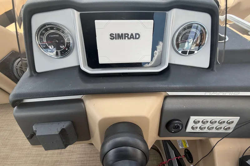 Slide: The Image of Dashboard of a 2021 Harris Solstice 230 boat with Simrad display and gauges. - 52