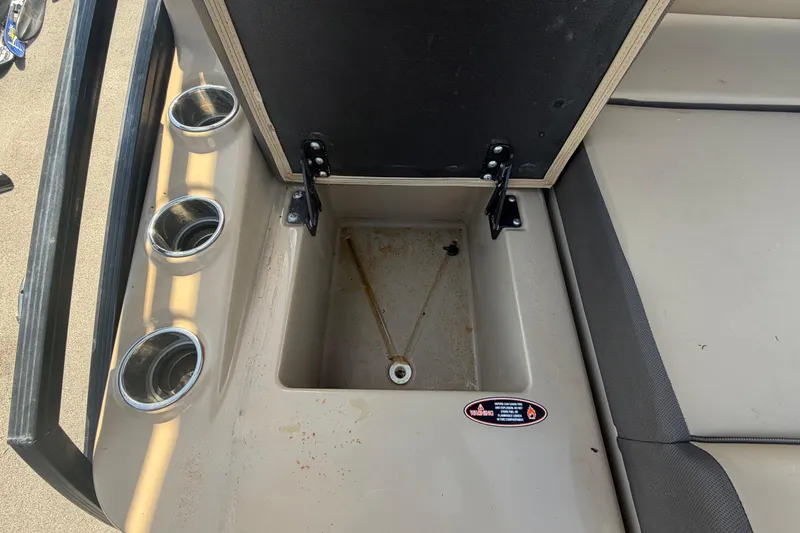 Slide: The Image of Open storage compartment on 2021 Harris Solstice 230 boat with cup holders. - 37