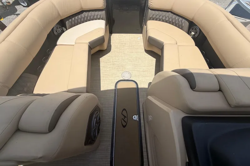 Slide: The Image of Interior of 2021 Harris Solstice 230 pontoon boat with beige seating and spacious layout. - 57
