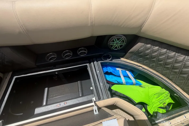 Slide: The Image of Interior storage of 2021 Harris Solstice 230 boat with life jackets and speaker. - 64
