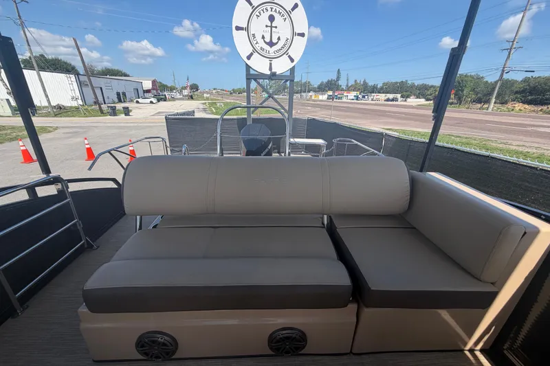 Slide: The Image of 2021 Harris Solstice 230 pontoon boat interior with beige seating and nautical decor. - 19