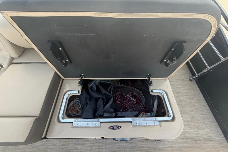 Slide: The Image of An open storage compartment on a boat with wires and equipment. - 38