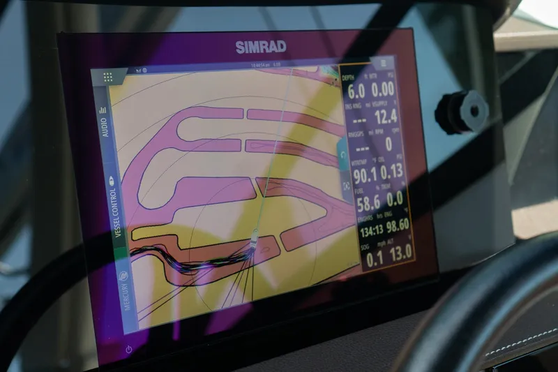 Slide: The Image of Simrad navigation display on 2022 Sea Ray SDX 290 boat dashboard. - 42