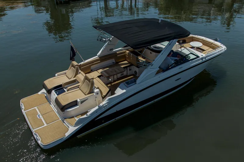Slide: The Image of 2022 Sea Ray SDX 290 boat with sleek design and spacious seating on calm water. - 15