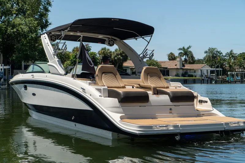 Slide: The Image of 2022 Sea Ray SDX 290 boat on calm water, featuring sleek design and luxurious seating. - 6