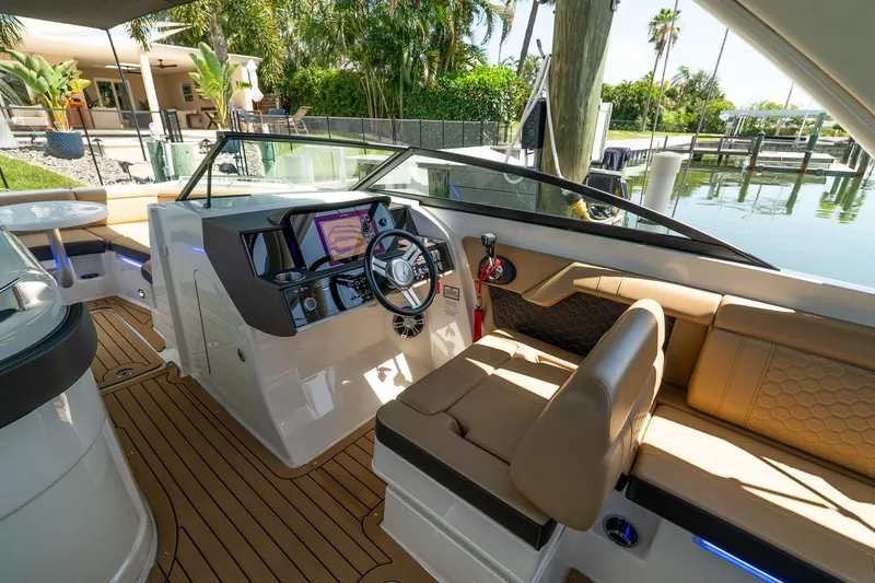 Slide: The Image of 2022 Sea Ray SDX 290 boat interior with modern dashboard and luxurious seating. - 27