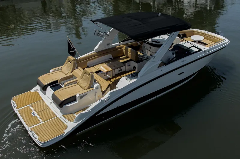 Slide: The Image of 2022 Sea Ray SDX 290 boat with sleek design and luxurious seating on calm water. - 10