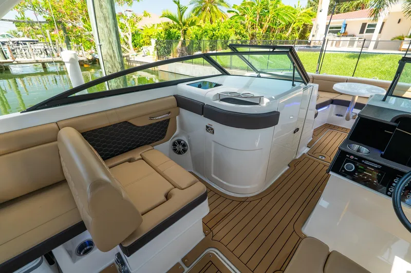 Slide: The Image of 2022 Sea Ray SDX 290 boat interior with luxurious seating and modern dashboard design. - 26
