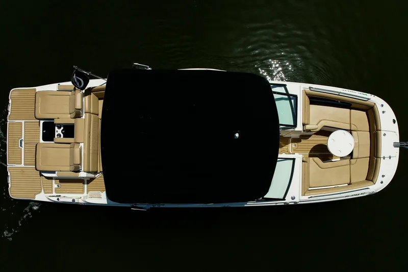 Slide: The Image of Overhead view of 2022 Sea Ray SDX 290 boat with tan seating and black canopy. - 11