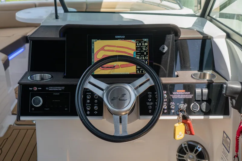 Slide: The Image of 2022 Sea Ray SDX 290 helm with navigation display and controls. - 24