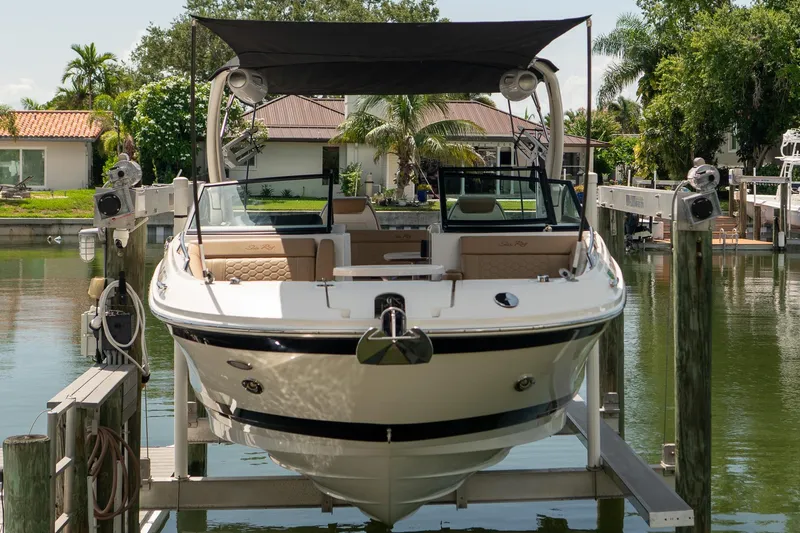 Slide: The Image of 2022 Sea Ray SDX 290 boat docked, featuring sleek design and spacious interior. - 20