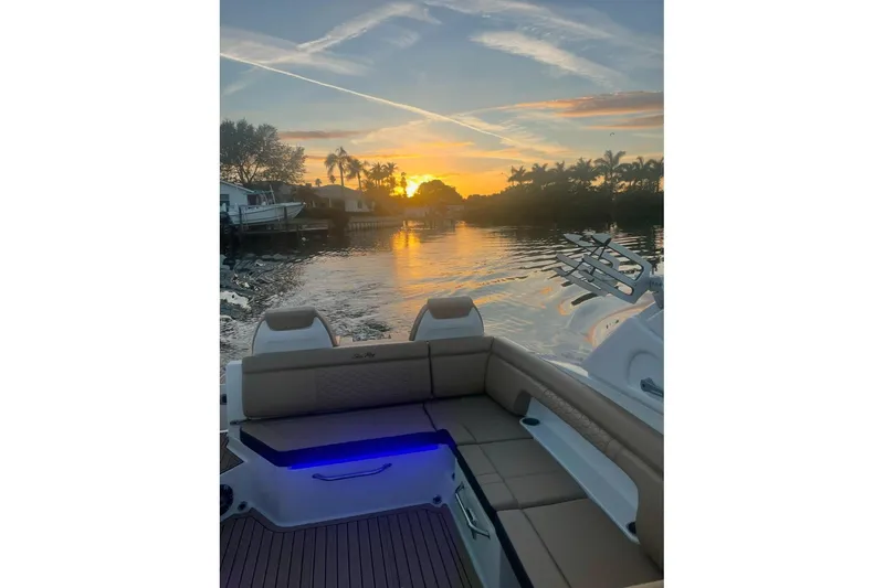 Slide: The Image of 2022 Sea Ray SDX 290 boat at sunset on a tranquil waterway. - 65