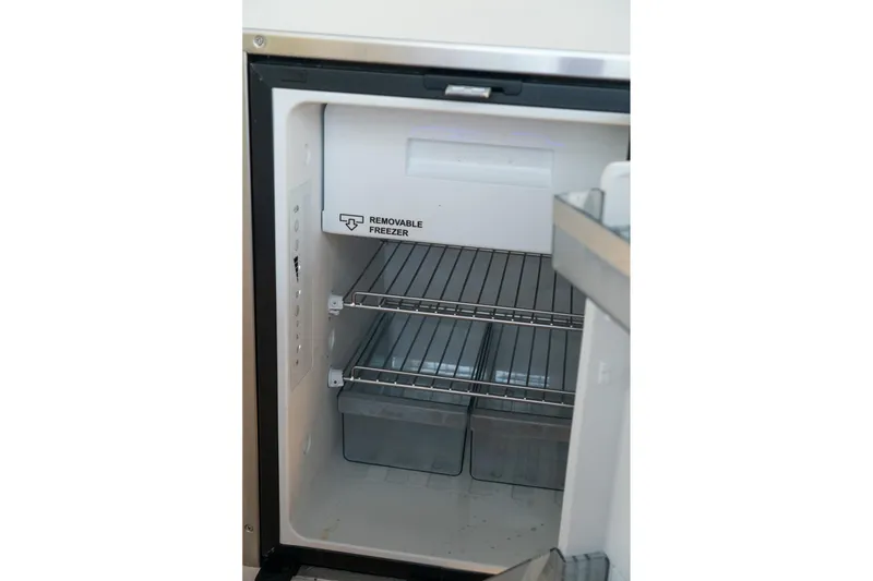 Slide: The Image of Open refrigerator with removable freezer in 2022 Sea Ray SDX 290 boat. - 52