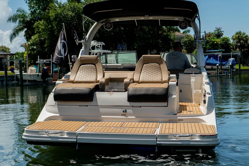 Slide: The Image of 2022 Sea Ray SDX 290 boat with luxurious seating and teak swim platform. - 16
