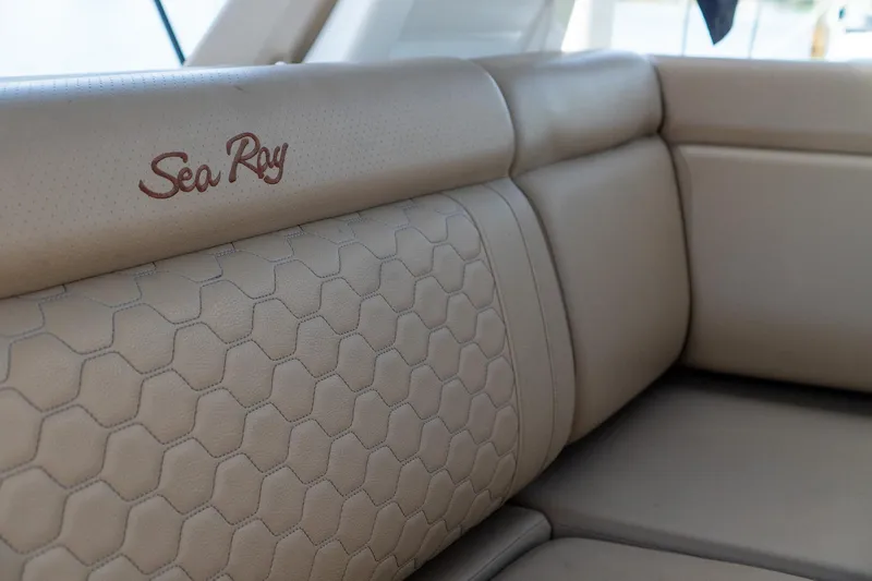 Slide: The Image of Luxurious beige seating on 2022 Sea Ray SDX 290 boat, featuring hexagonal stitching. - 54