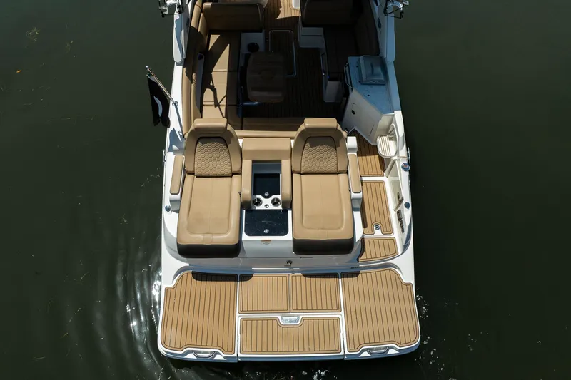 Slide: The Image of 2022 Sea Ray SDX 290 boat with spacious deck and luxurious seating on water. - 14
