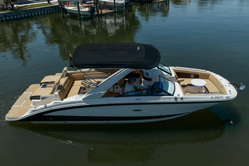 Slide: The Image of 2022 Sea Ray SDX 290 boat cruising on calm water, featuring spacious seating and sleek design. - 9