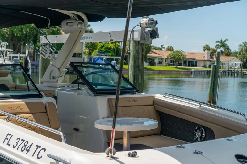 Slide: The Image of 2022 Sea Ray SDX 290 boat docked, featuring luxurious seating and sleek design. - 23