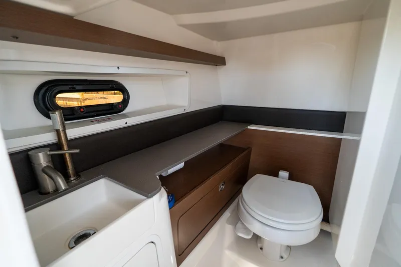 Slide: The Image of Luxurious 2022 Sea Ray SDX 290 boat bathroom with modern fixtures and compact design. - 38