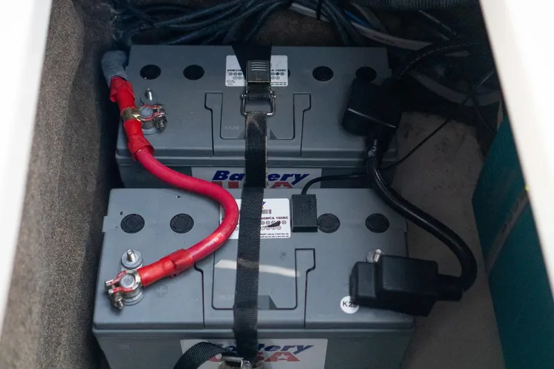 Slide: The Image of Battery compartment of 2022 Sea Ray SDX 290 boat, featuring dual marine batteries. - 48