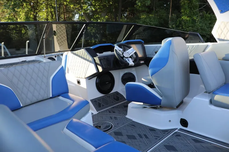 Slide: The Image of 2024 Tigé 22RZX boat interior with blue and gray seating, modern dashboard, and stylish design. - 4