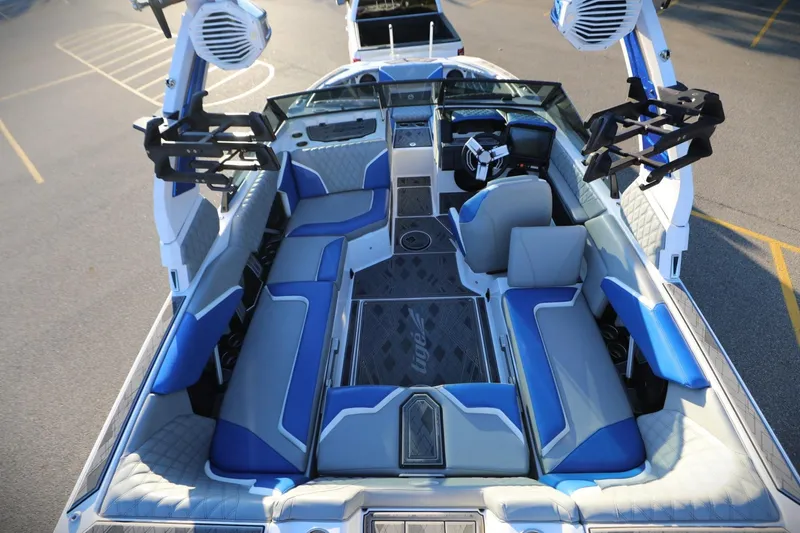 Slide: The Image of 2024 Tigé 22RZX boat interior with blue and gray seating, advanced dashboard, and speakers. - 6