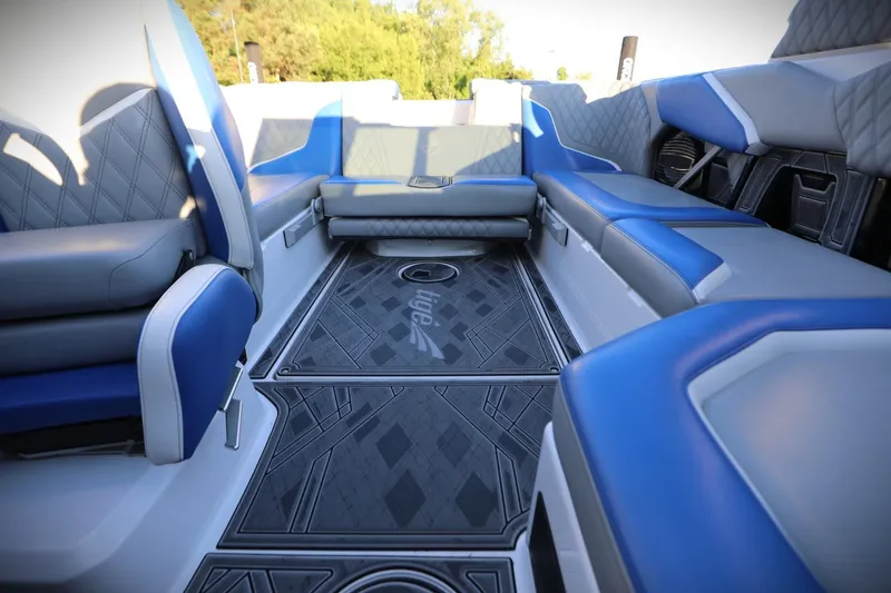 Slide: The Image of 2024 Tigé 22RZX interior with blue and gray seating, featuring stylish flooring design. - 16