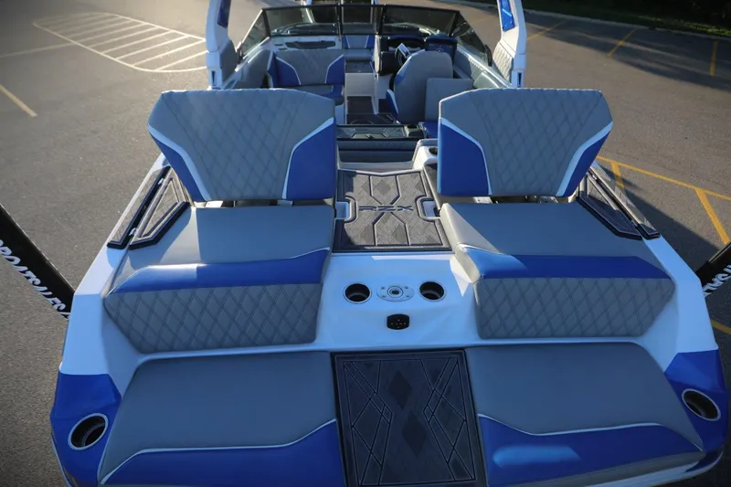 Slide: The Image of 2024 Tigé 22RZX boat interior with blue and gray seating, showcasing modern design. - 17