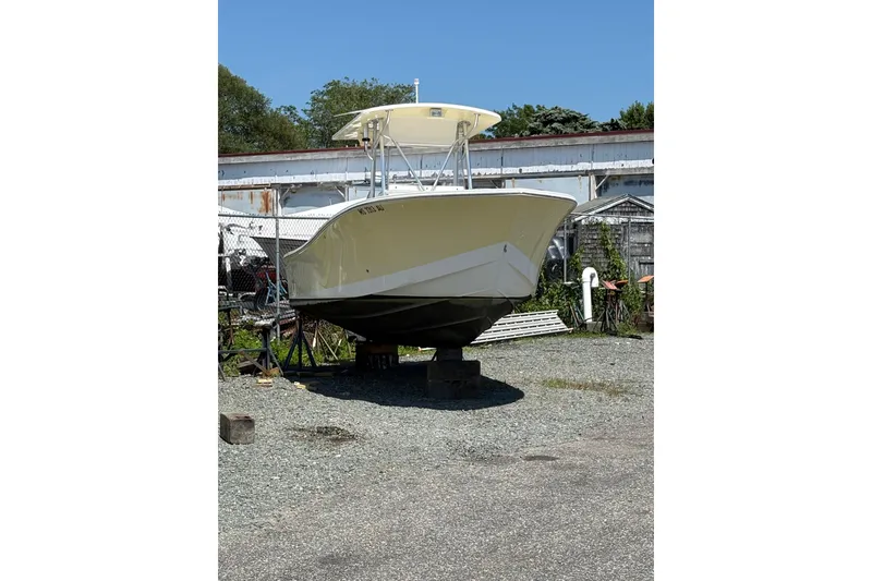 Slide: The Image of 2008 Regulator 23 Forward Seating boat on dry land, sunny day, storage area. - 4