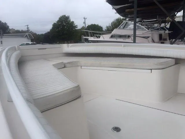 Slide: The Image of The image shows the bow of a 2008 Regulator 23 Forward Seating boat with white upholstery. - 8